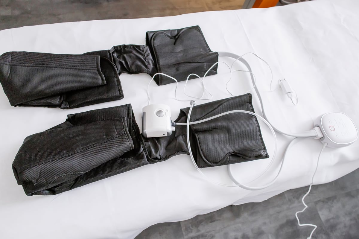 Full Leg Air Compression Boots on Massage Table — Professional Pneumatic Lymphatic Drainage Treatment for Legs, Circulation Therapy